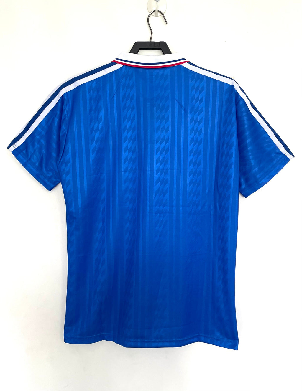 Blue sports jersey with white stripes on a hanger against a white background