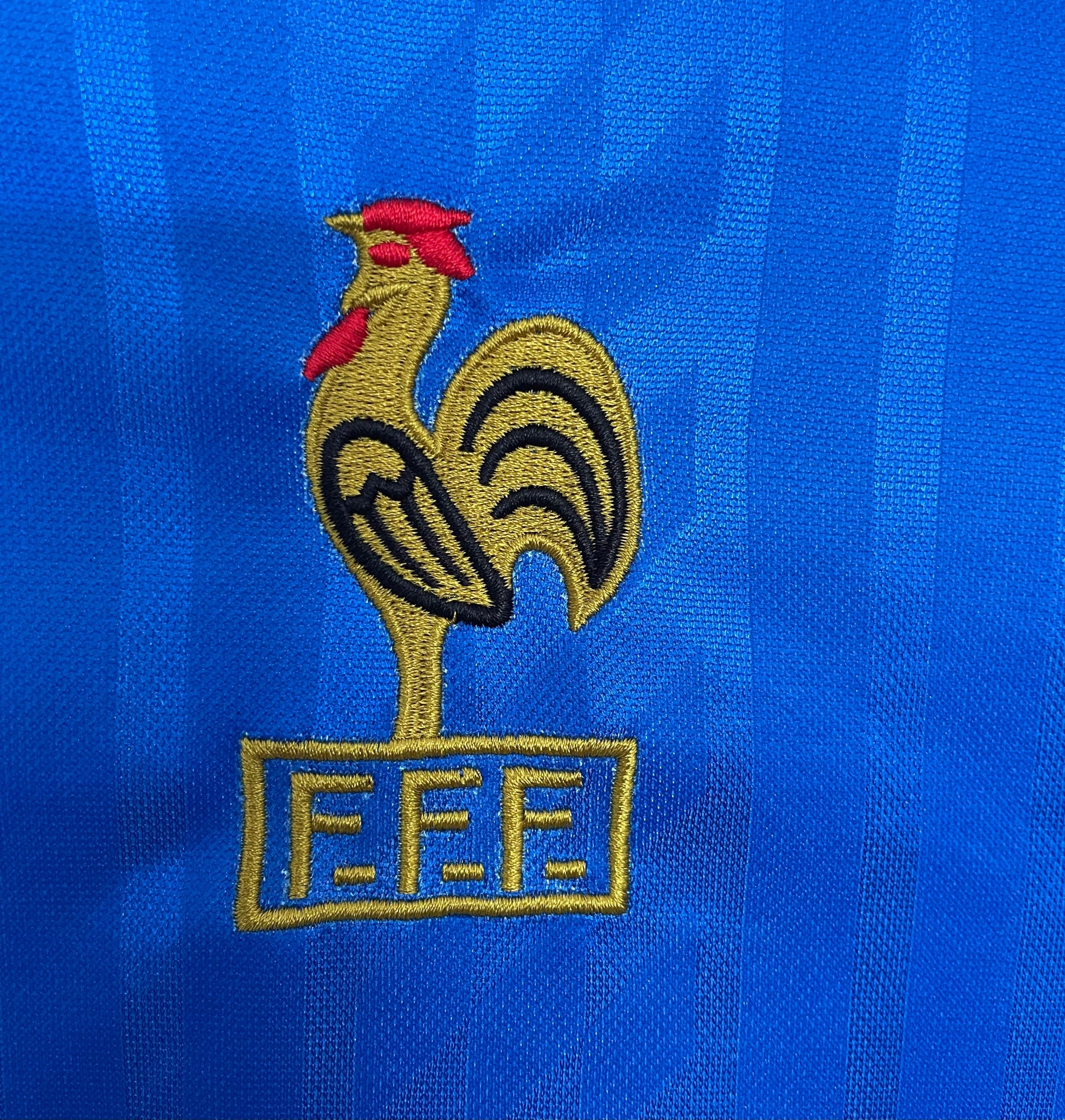 Embroidered France rooster logo with 'FFF' on a blue background