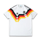 White Germany 1990 jersey with Adidas logo and German flag design on a white background