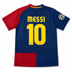 Back view of a soccer jersey with 'MESSI' and the number '10' in yellow on a navy blue background, with red sleeves and a red block at the bottom, plus a Champions League patch on the right shoulder.