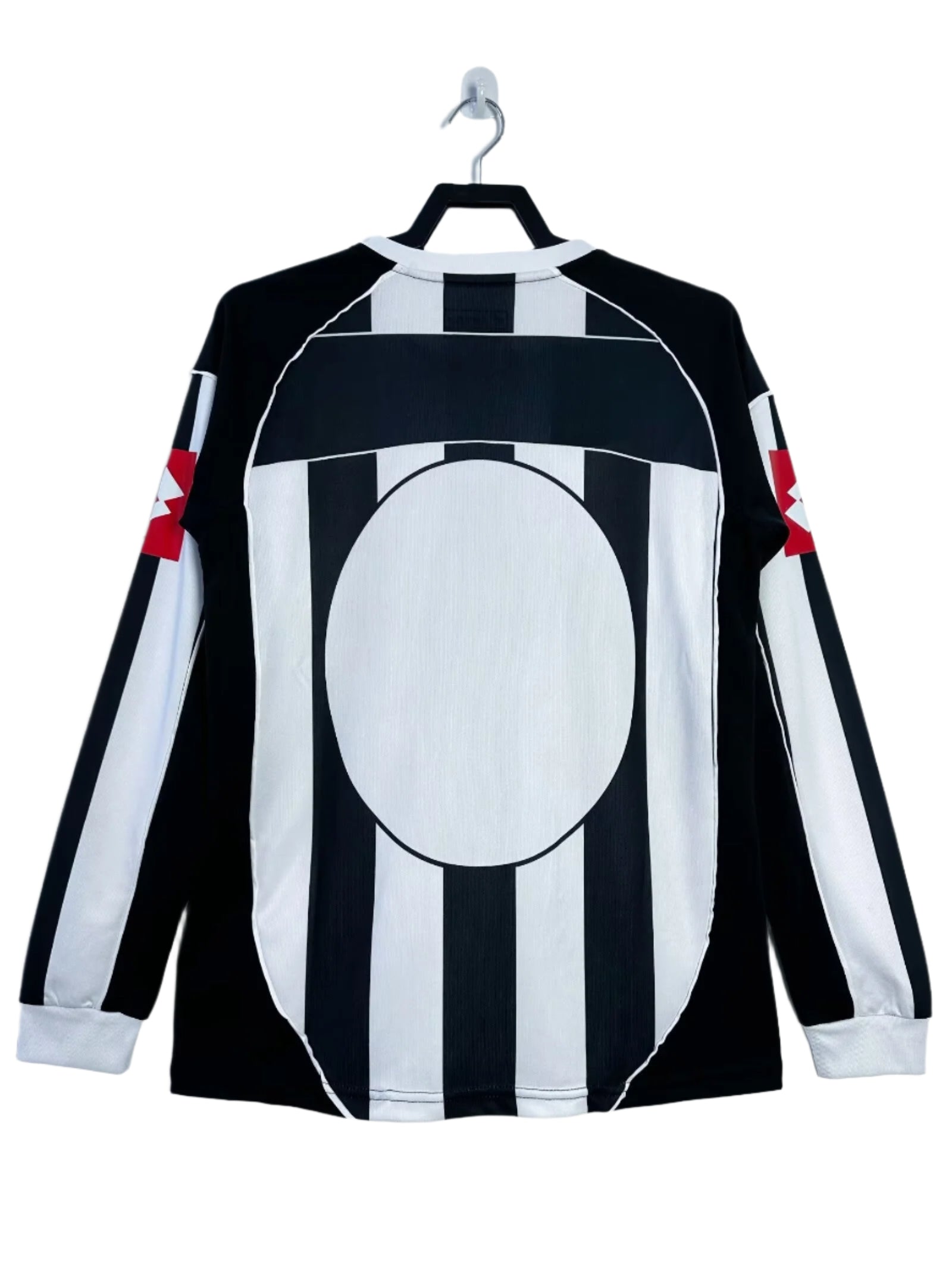 Black and white striped shirt with red accents on a hanger against a white background