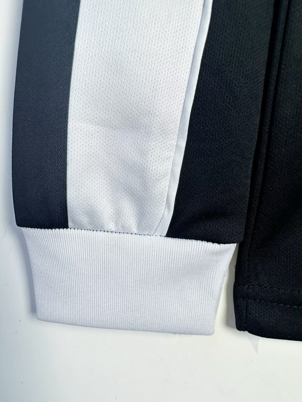 Close-up of a black and white striped fabric on a light gray background