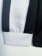 Close-up of a black and white striped fabric on a light gray background