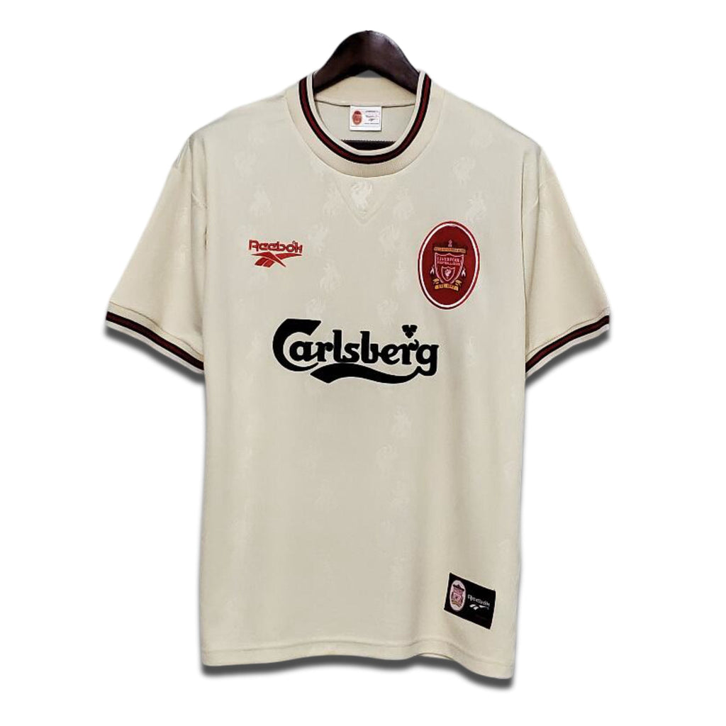 A classic Liverpool FC away jersey from the 1996/1997 season, in ecru color with green and black trim, featuring the Carlsberg sponsor and Adidas detailing.