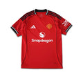 Red Manchester United 2025/26 season football shirt with branding on a white background.