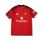 Red Manchester United 2025/26 season football shirt with branding on a white background.