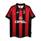 Red and black sports jersey with Opel and Adidas logos on a white background