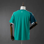 Green sports jersey on a mannequin against a gray background