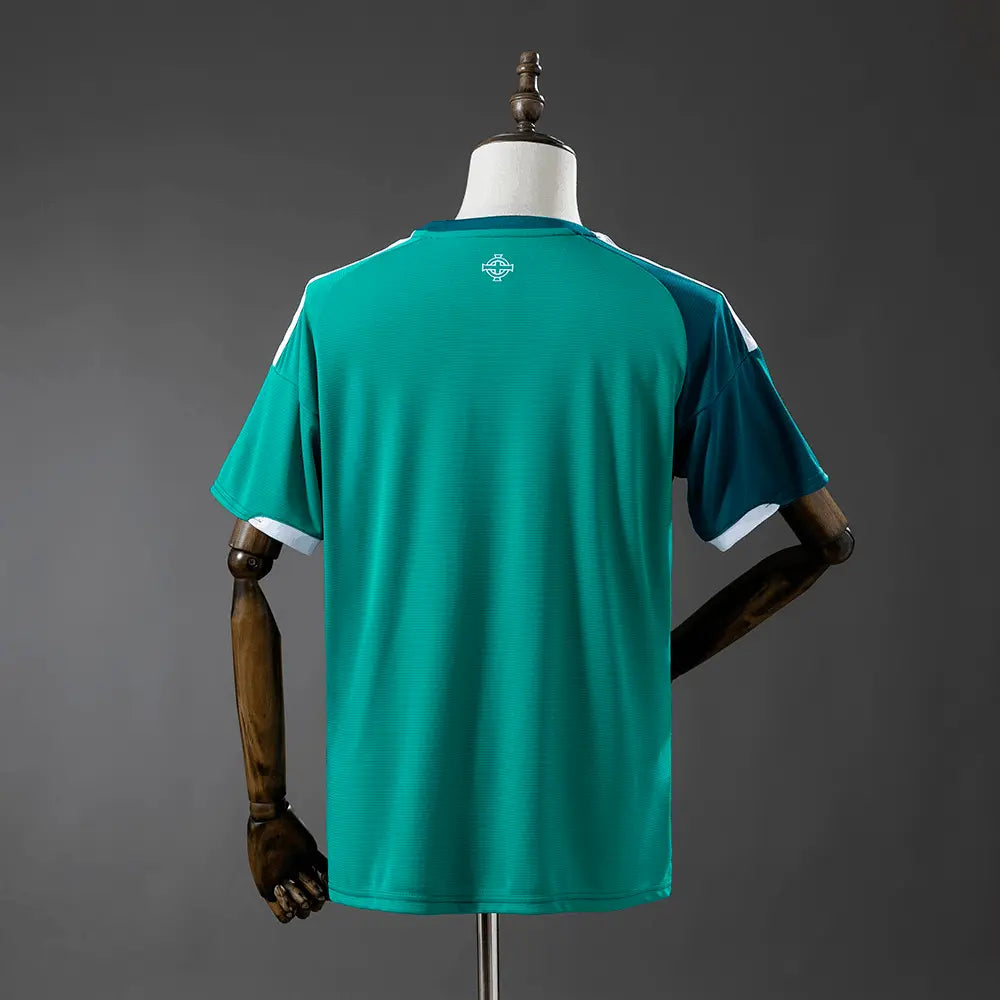 Green sports jersey on a mannequin against a gray background