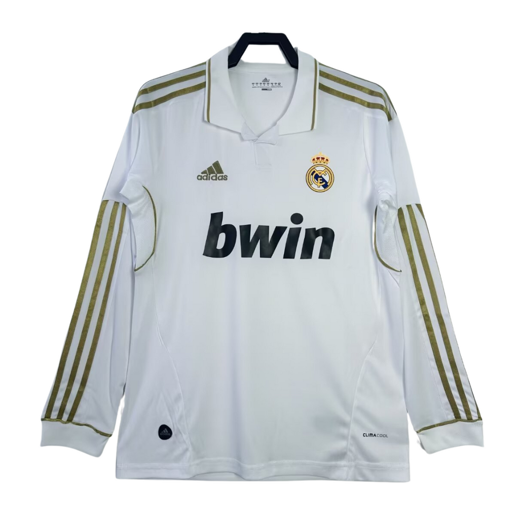 White soccer jersey with gold stripes, Adidas logo, Real Madrid emblem, and bwin sponsorship on a white background.