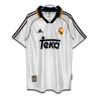 Real Madrid 1999/00 home shirt with TEKA sponsor logo, predominantly white with black and gold accents.