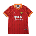 A red AS Roma soccer jersey by Diadora, featuring the white 'INA Assitalia' sponsor logo on the chest, the club crest, and orange accents on the collar and sleeve cuffs, displayed against a solid white background.