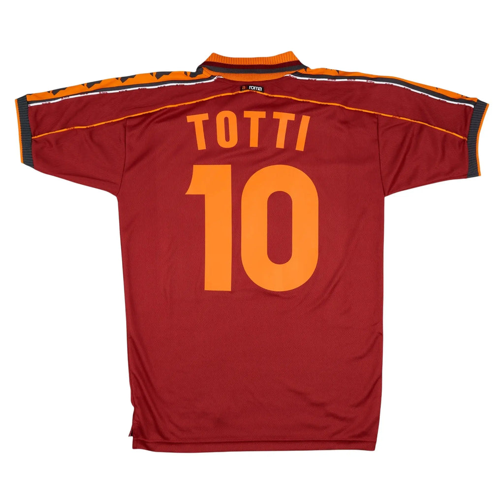 A red AS Roma soccer jersey shown from the back, featuring the player name 'TOTTI' and number '10' in orange. The jersey has orange and black striped shoulder details.