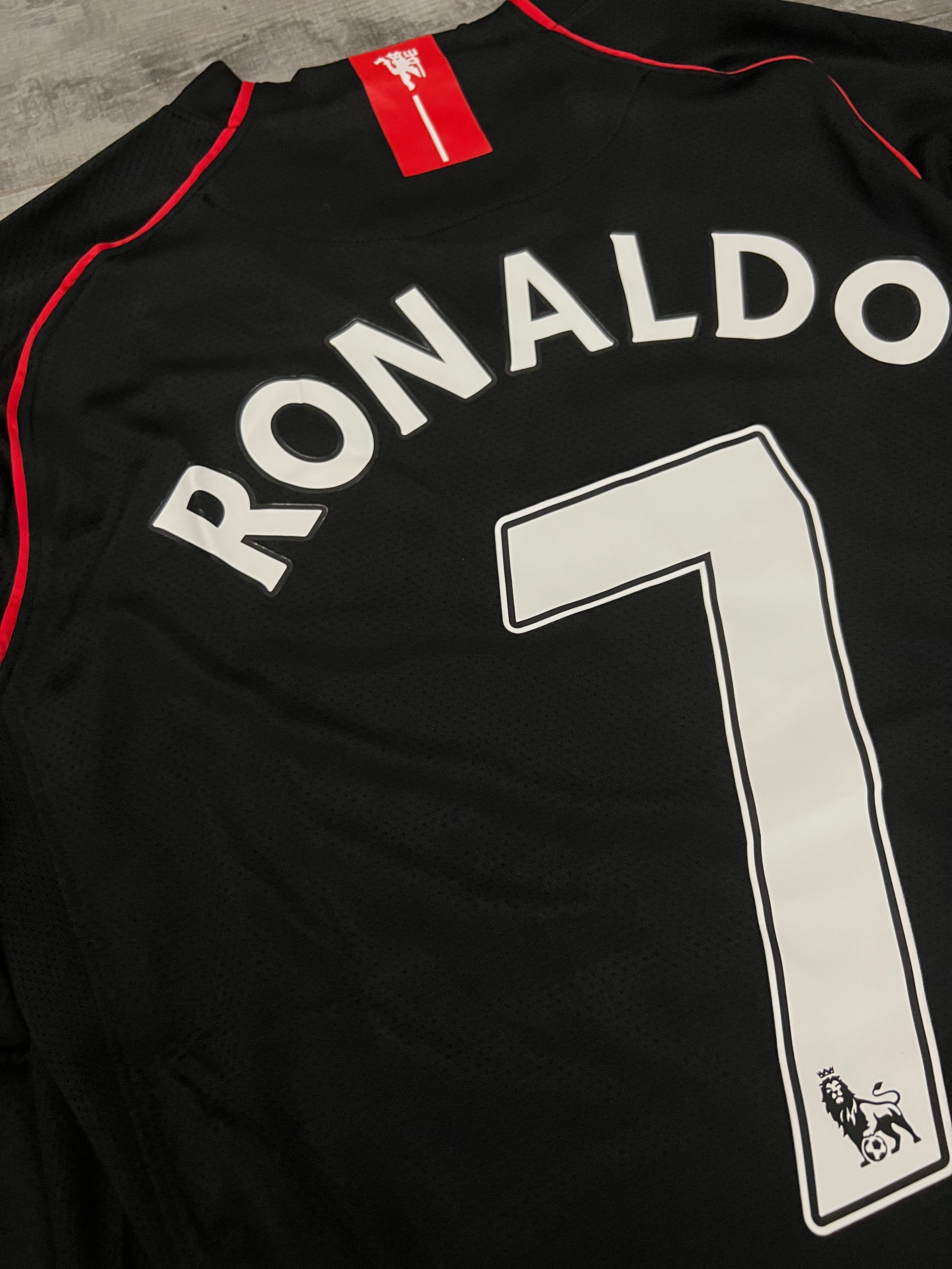 Black sports jersey with 'RONALDO' and number '7' on a gray surface