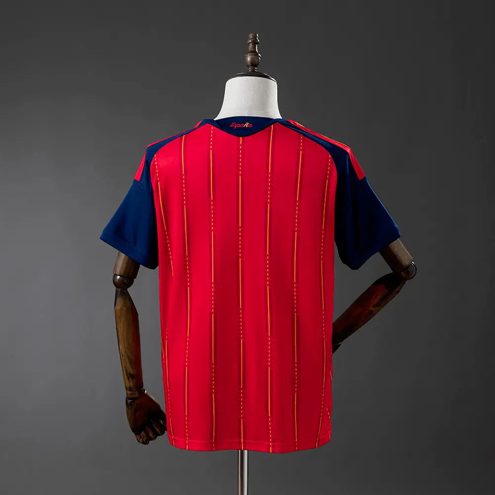 Red sports jersey with blue sleeves on a mannequin against a gray background