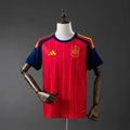Red sports jersey with blue sleeves on a mannequin against a gray background
