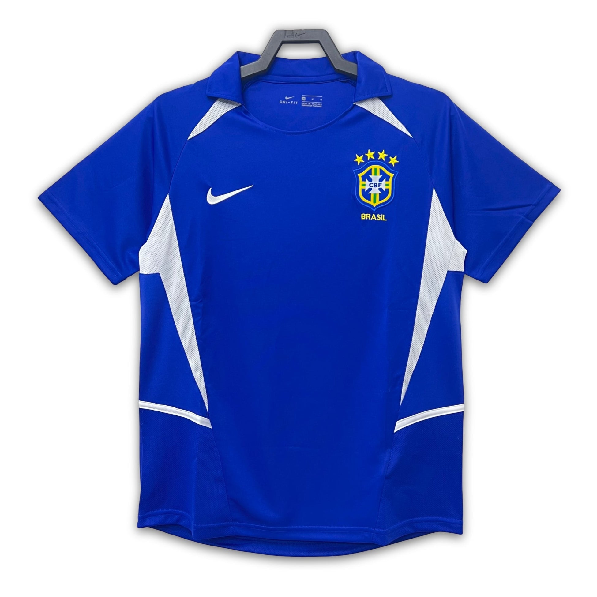 A blue soccer jersey with white accents, featuring the Brazil national team crest, displayed on a white background.