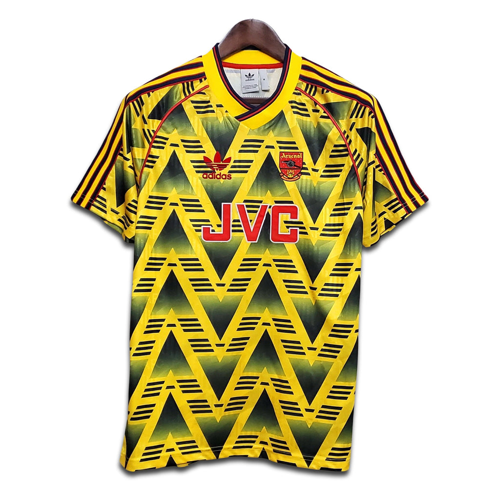 Yellow and black Arsenal Bruised banana shirt with JVC branding on a white background
