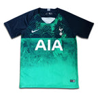 Green and navy sports jersey with 'AIA' and 'Tottenham' branding on a white background