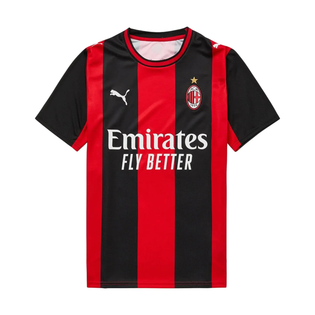 AC Milan home soccer jersey by Puma, featuring red and black vertical stripes with the club's crest and Emirates Fly Better sponsor logo on the front.