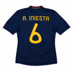 Back view of a navy blue short-sleeve soccer jersey with 'A. INIESTA' and the number '6' in yellow on the back, shown on a plain white background.