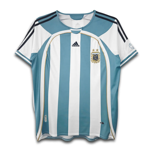 Argentina national football team home shirt from the 2006 FIFA World Cup, featuring sky blue and white vertical stripes with black accents, Adidas logo, and the Argentine national emblem.