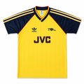 A vintage yellow and navy blue Adidas Arsenal soccer jersey with JVC sponsor branding on the front, displayed flat against a white background.