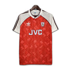 Red and white sports jersey with Adidas logo on a hanger