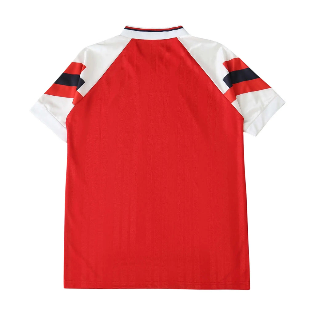 A red short-sleeve raglan t-shirt with white sleeves and navy and red striped accents on the shoulders, shown from the back on a white background.