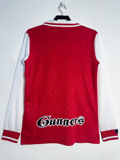 Red and white sports jersey with 'Gunners' logo on a white background