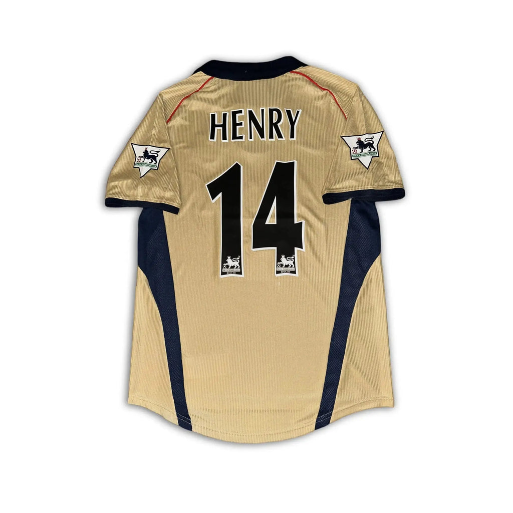 Arsenal 2001 02 SEGA gold away shirt sitting on a white background.