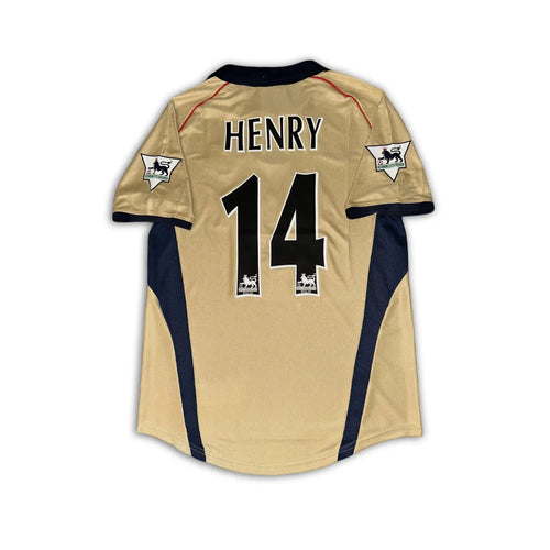 Arsenal 2001 02 SEGA gold away shirt sitting on a white background.