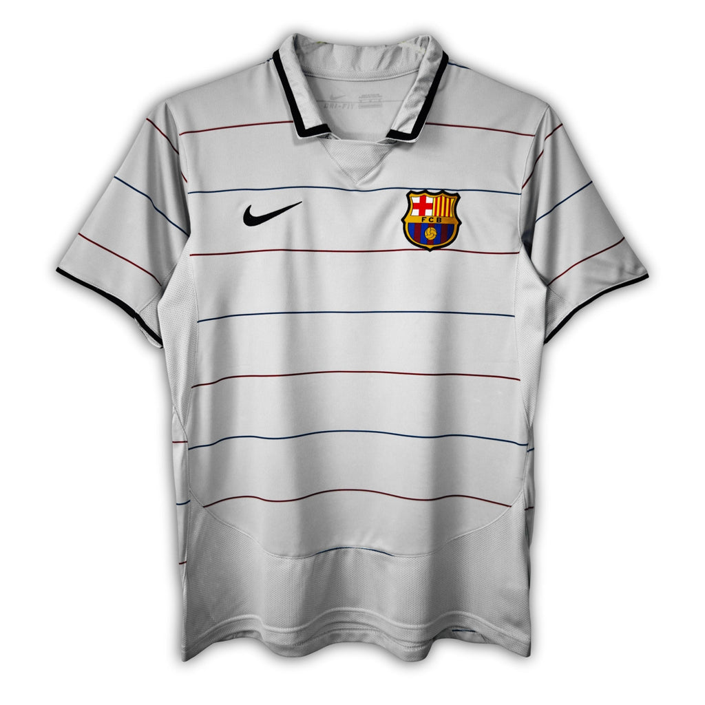 A gray short-sleeved soccer jersey with red and blue stripes, featuring the FC Barcelona crest and a Nike logo.