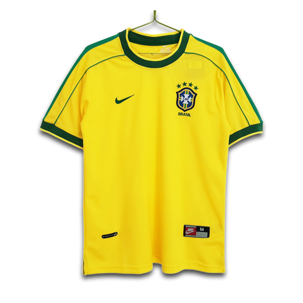 A retro Brazil national football team home jersey from the 1998 FIFA World Cup, featuring a vibrant yellow base with green trim, and the Nike logo.