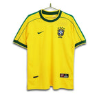 A retro Brazil national football team home jersey from the 1998 FIFA World Cup, featuring a vibrant yellow base with green trim, and the Nike logo.