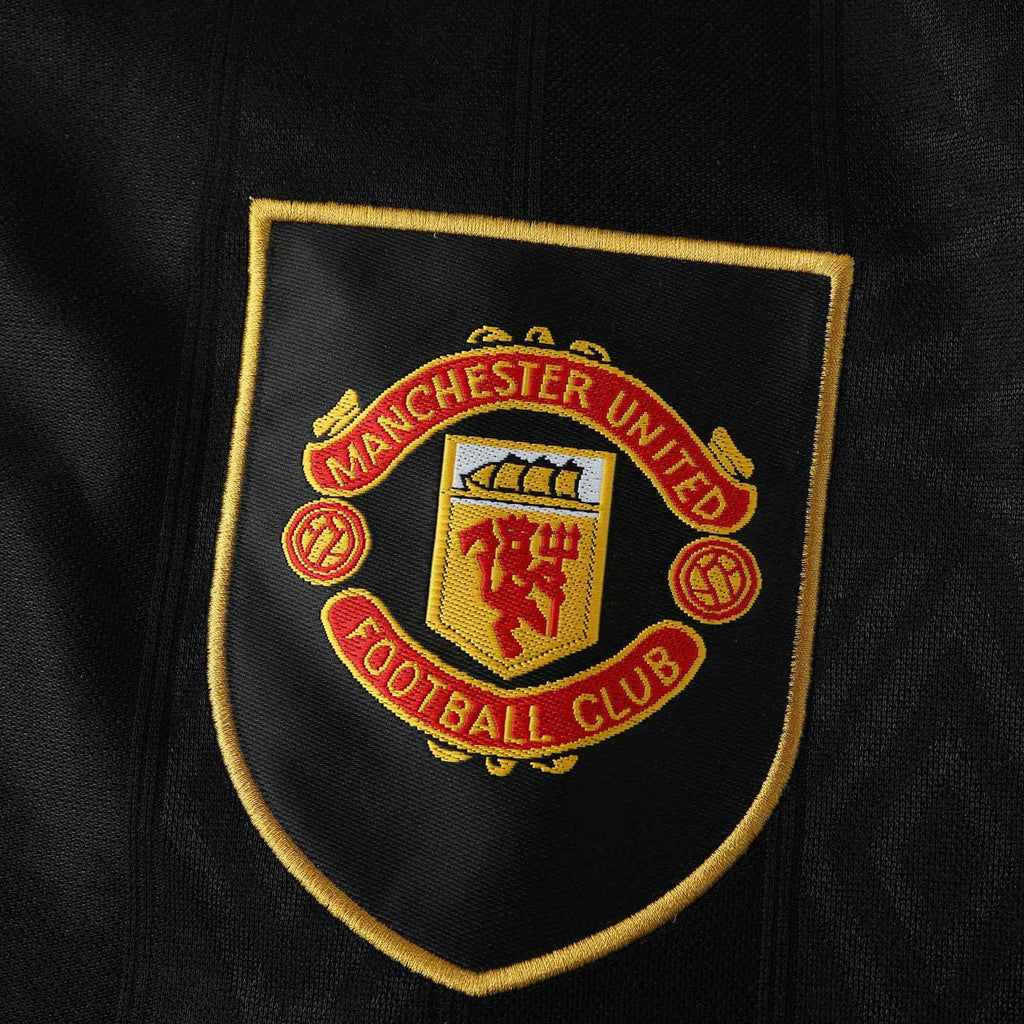 Manchester United Football Club logo on a black background