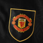 Manchester United Football Club logo on a black background