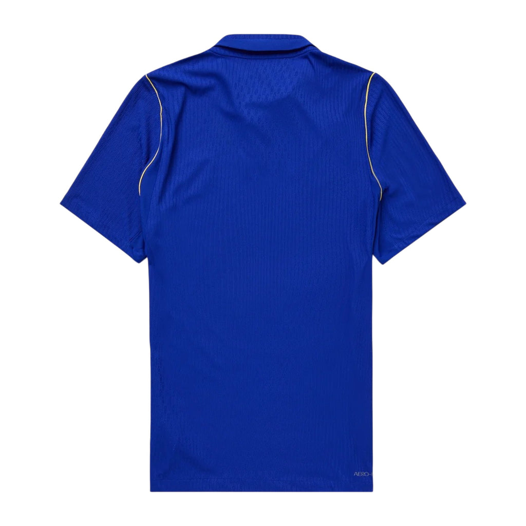 A royal blue short-sleeve athletic jersey shown from the back, featuring subtle vertical ribbing and thin light yellow piping along the shoulders, set against a plain white background.