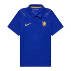 A royal blue Chelsea FC short-sleeve polo shirt by Nike, featuring a yellow Nike swoosh on the right chest and the Chelsea crest on the left chest, displayed against a solid white background.