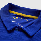 Close-up of a blue Chelsea sports jersey with yellow accents and Nike logo.