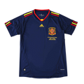 A navy blue Adidas Spain soccer jersey with red and yellow trim on the collar and sleeve cuffs, featuring the Spain national team crest and gold Adidas logo on the chest, displayed against a solid black background.