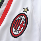 Elite Retro Kits AC Milan 2006/07 away kids kit featuring the embroidered club crest and gold star on white fabric.
