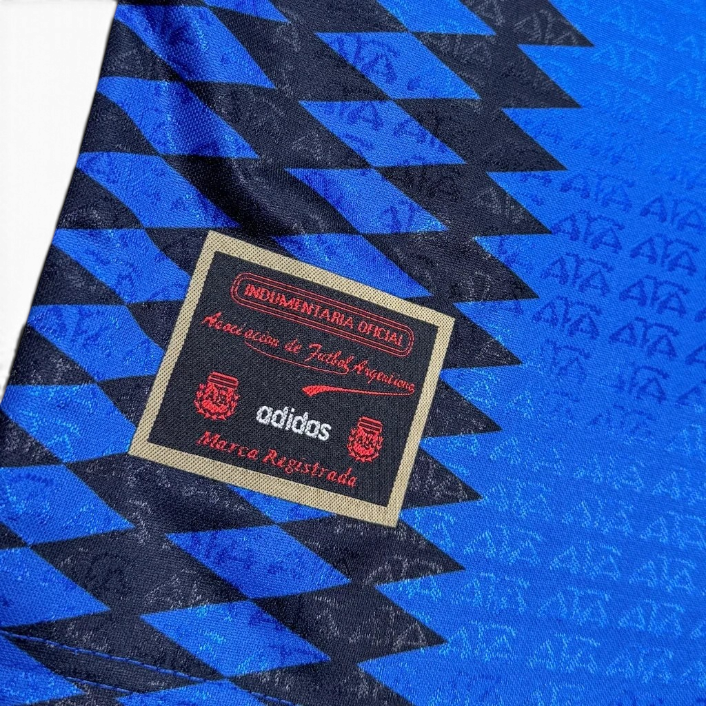 Elite Retro Kits Argentina 1994 away kids kit featuring blue and black diamond pattern with official AFA crest tag
