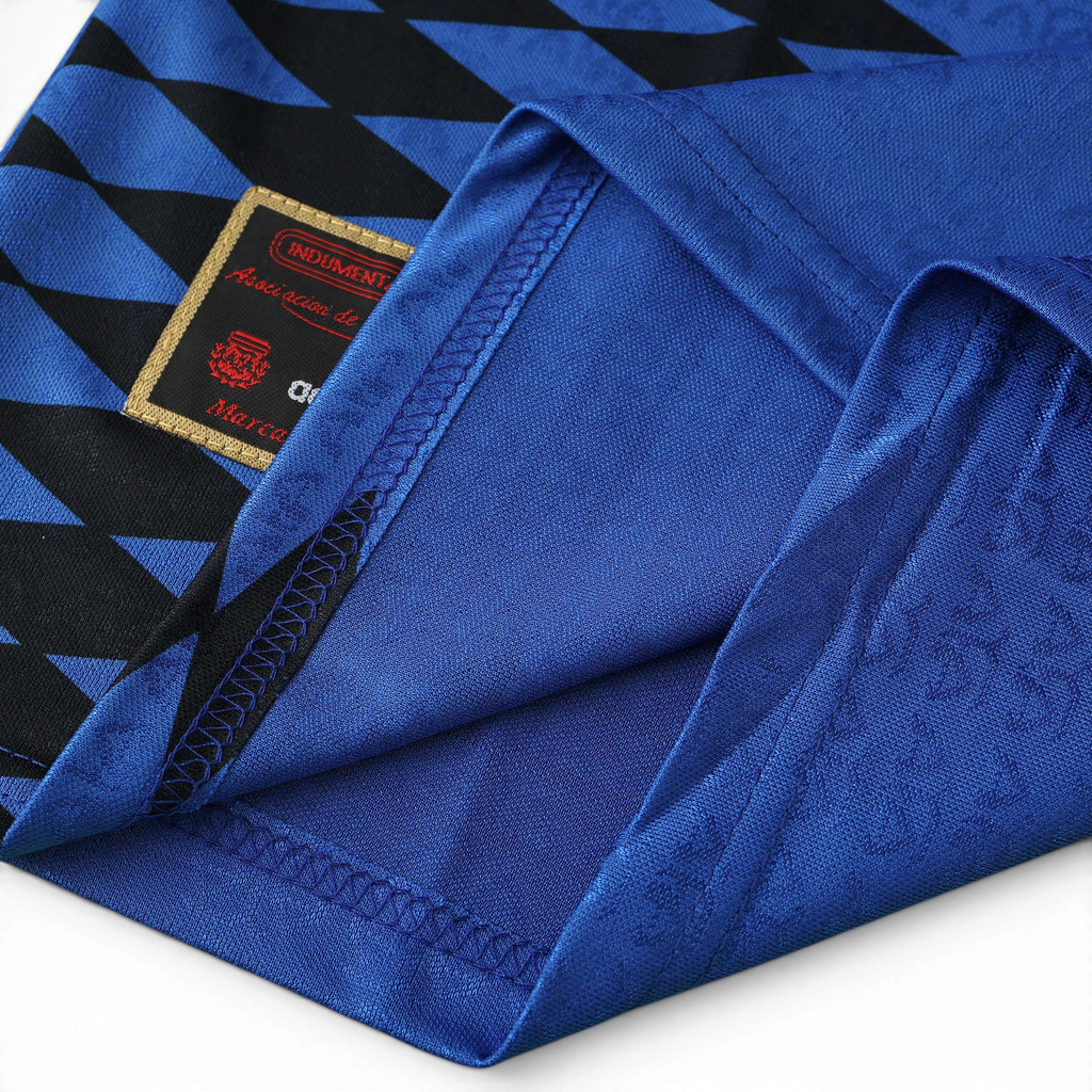Elite Retro Kits Argentina 1994 away shirt featuring deep blue fabric, black diamond graphics, and AFA crest detail.