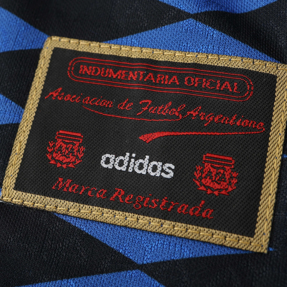 Elite Retro Kits Argentina 1994 away shirt detail showing the official Adidas AFA embroidered patch on blue fabric