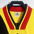 Elite Retro Kits Arsenal 1993/94 away shirt featuring a yellow, red, and navy v-neck collar with adidas branding.