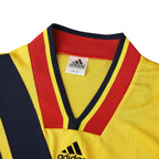 Elite Retro Kits Arsenal 1993/94 away shirt featuring a yellow, red, and navy v-neck collar and adidas branding.