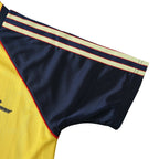 Elite Retro Kits Arsenal 1988/90 away shirt sleeve detail featuring yellow fabric and navy trim with red piping.