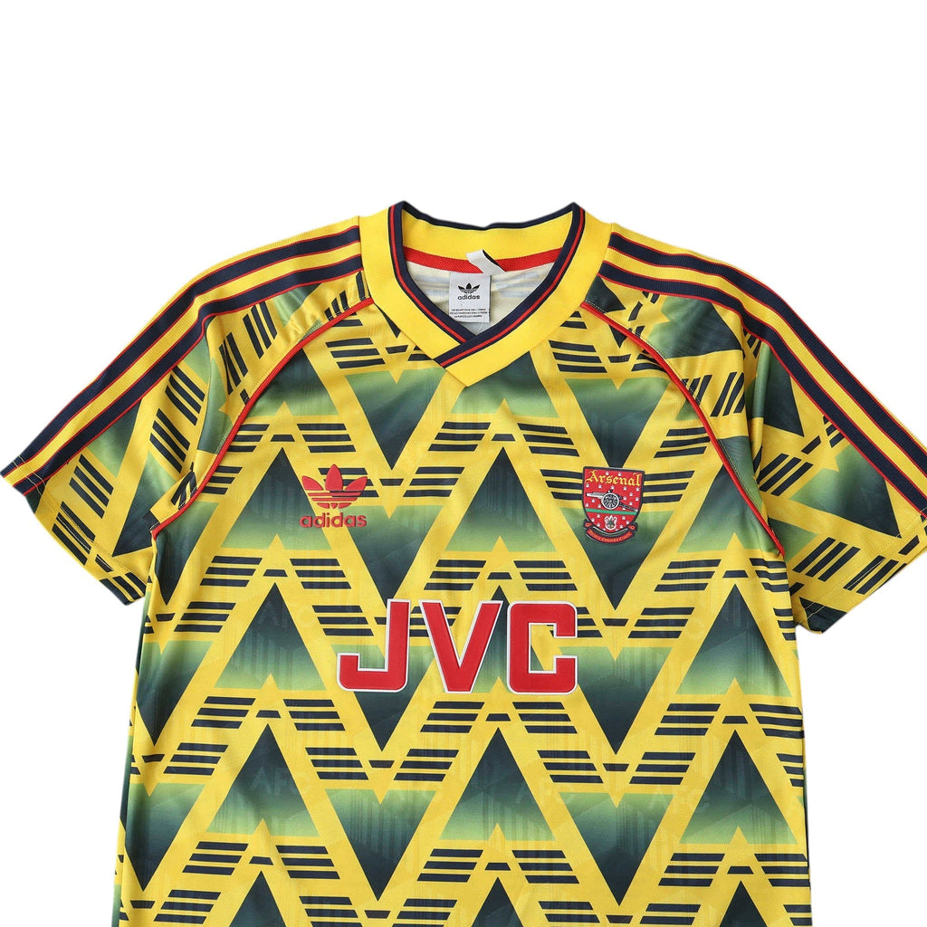 Elite Retro Kits Arsenal 1991-93 Bruised Banana away shirt featuring yellow base, navy jagged pattern, and JVC logo.