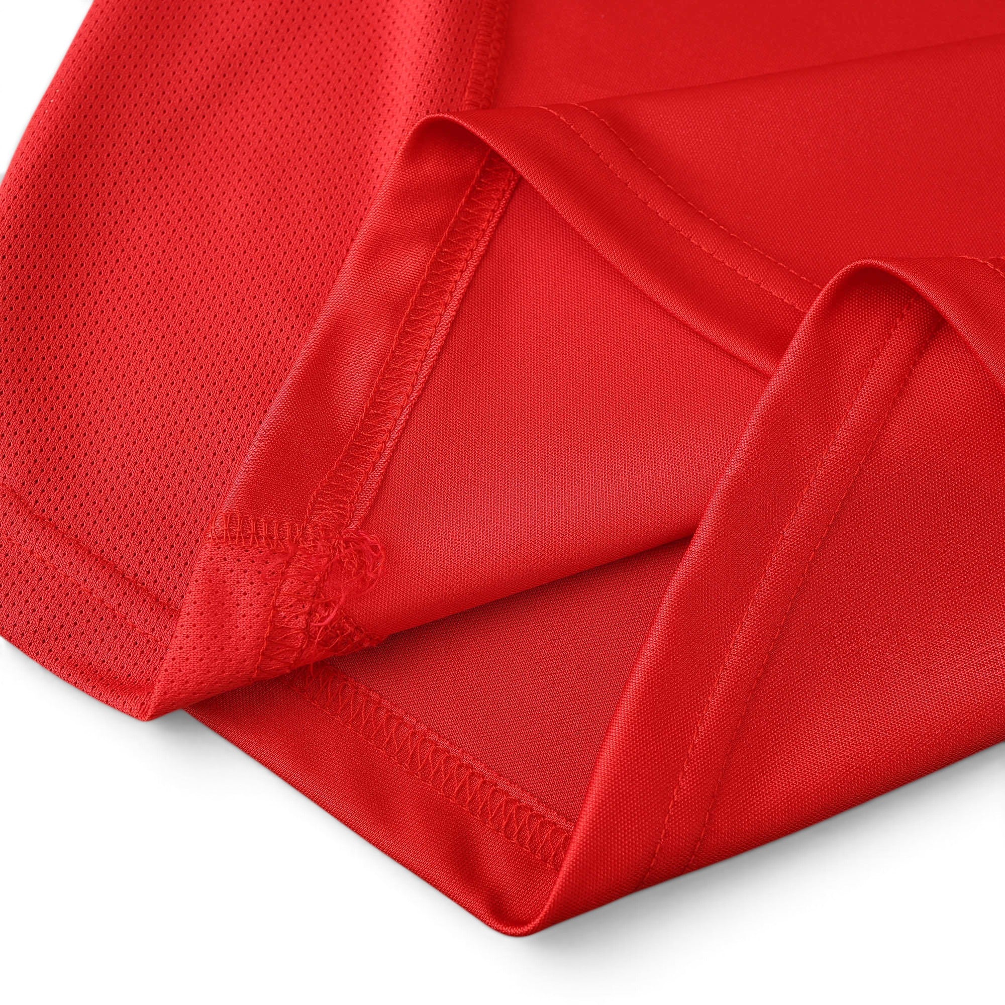 Close-up of the red breathable mesh fabric on an Elite Retro Kits Arsenal 2001/02 home football shirt.